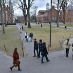 Pedestrians crossed the Harvard University Campus.
